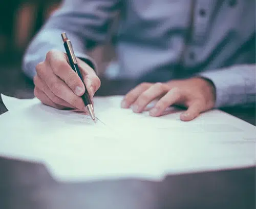 man writing at a desk